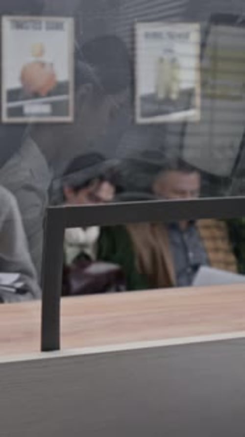 Senior Man Interacting with Bank Teller in Modern Office