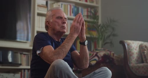 Senior Man Meditating Peacefully at Home