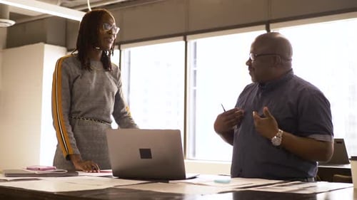 Business People with Laptop and Paperwork Meeting in Office 2529 Years