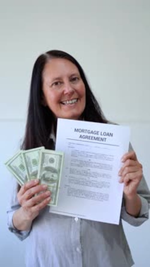 Woman Holds Mortgage Loan Agreement and Money