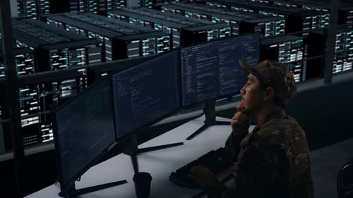 Side View Of Asian Military Thinking About Something While Write Code In Data Center