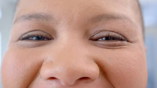 Portrait of happy eyes of african american woman in hospital, slow motion