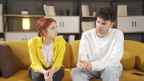 Young Couple Sit Apart After An Argument