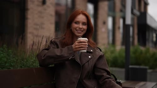 Portrait of Smiling Confident Redhead Woman Enjoying Peaceful Coffee Break Outdoors in City
