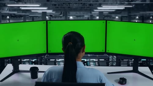 Asian Woman Working With Mock Up Multiple Computer Monitor In Data Center