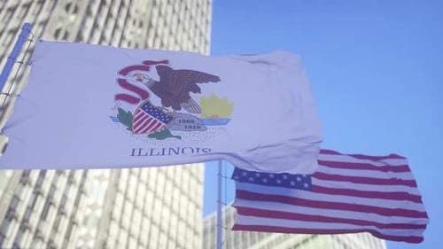 Waving Illinois State and USA Flags Against Blue Sky