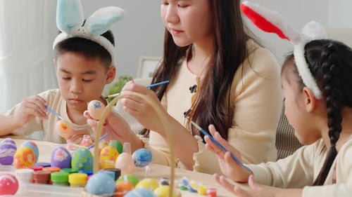 Family Decorating Easter Eggs with Bunny Ears