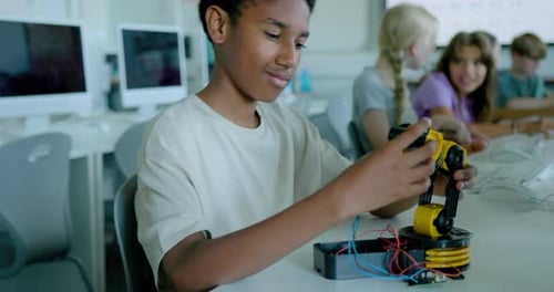 School Children in STEM Computer Classroom, Looking at Robot arm