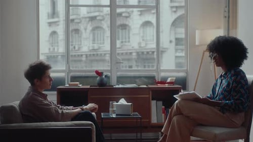 Young Woman Having Consultation with Psychologist