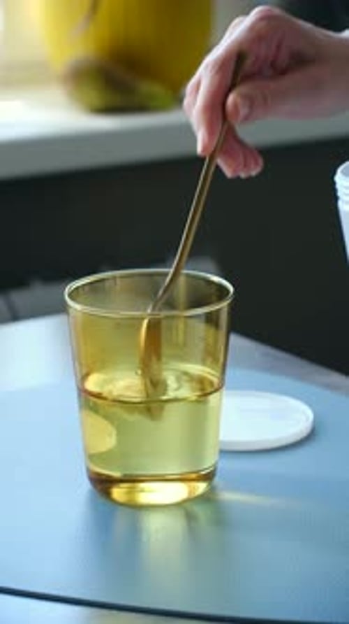 Person Mixing Nutritional Supplement Powder in Water