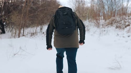 Snowy Solo Hike Adventurous American Trekker Walk in Winter Wonderland Back View