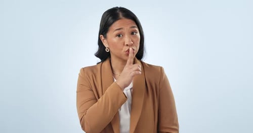Studio, secret or face of woman with mystery, gossip or company privacy on blue background