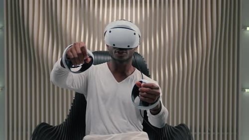 Young Adult Playing VR Game With Headset