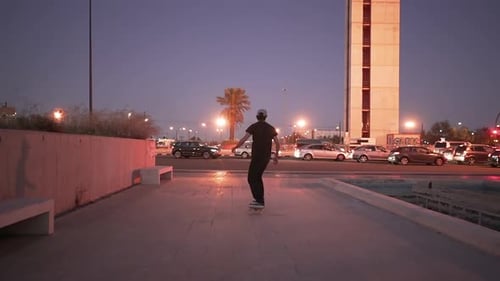 Stylish Man Skating Around Concrete Square During Blue Hour Back and Forth