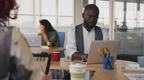 Jeune homme noir adulte au travail au bureau