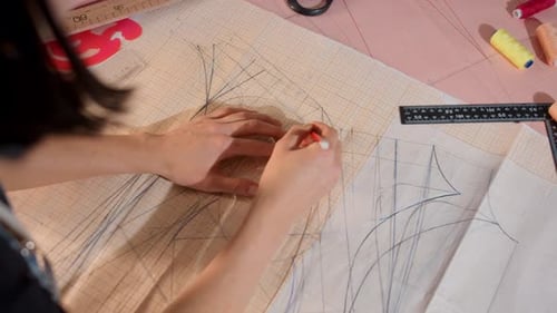 A Person is Drawing a Dress on a Piece of Paper