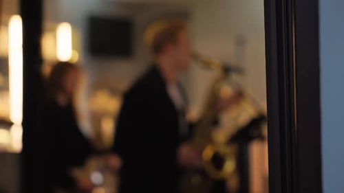 Enjoy an Enchanting Live Jazz Performance Featuring a Talented Saxophonist in a Cozy and Inviting
