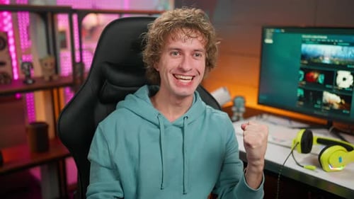 Young Man Celebrates Achievement in Gaming Chair