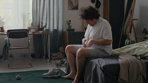 Young Man Touching His Belly
