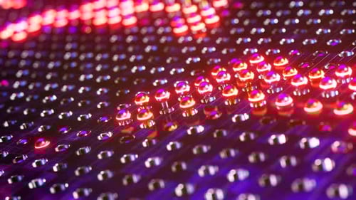 Esferas rojas luminosas que se mueven en ondas. Animación en bucle infinito