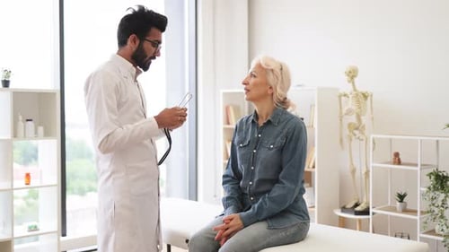 Doctor Examines Patient With Stethoscope in Office