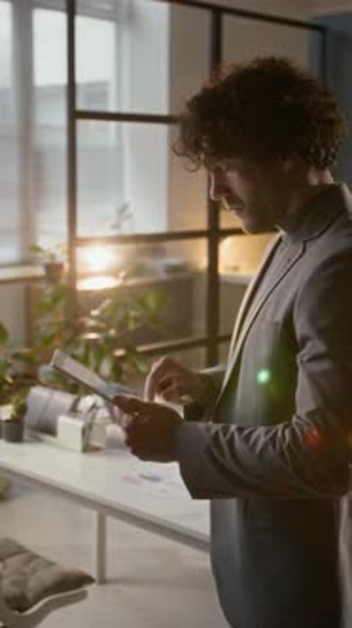 Man in Suit Using Tablet in Office