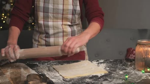 Woman Rolling Dough for Christmas Cookies Indoors