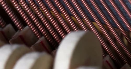 Piano Hammers Striking Strings Close Up View