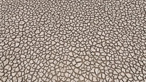 Drone view capturing a severely dried up terrain with deep cracks.