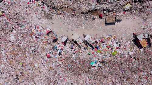 Aerial view from top of landfill site with garbage cart and dustman