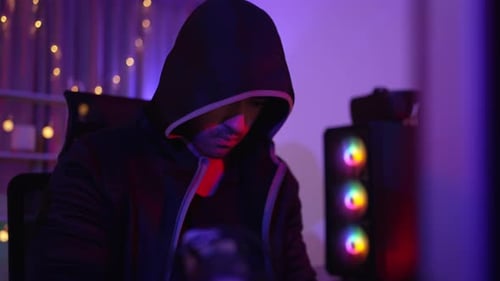 Young Adult Wearing Hoodie Working on Computer