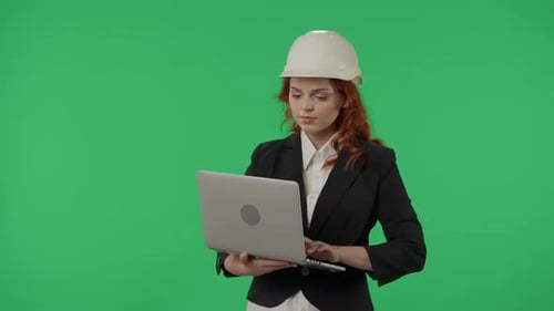 A Woman Architect Works on a Laptop Studies Plans Prints Reports Business Woman in a Protective