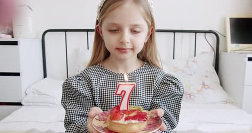 Happy Girl Celebrating Seventh Birthday at Home