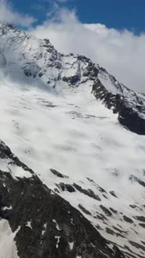 Scenic Mountain View with Snow and Clouds