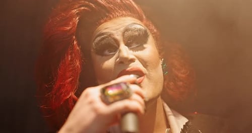 Drag artist, mic and person singing with creative expression for show, talent and audience