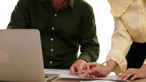 Architect compare hand writing with blueprint detail with laptop. Delineation.