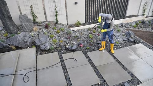 Adult Pressure Washing Concrete Pathway Outdoors