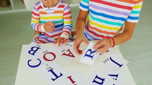 Child and Young Adult with Alphabet Flashcards