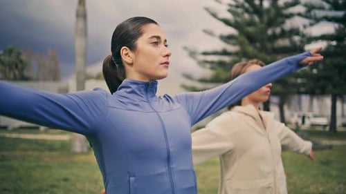 Yogi Women Raising Arms Training At Park Closeup. Two Focused Ladies Stretching Hands Making Morn...