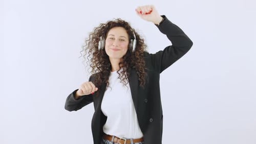 Woman with Headphones Dances Happily in Studio