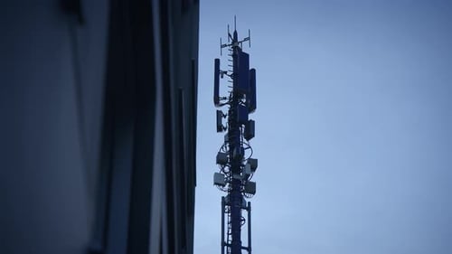 A Tall Telecommunication Tower Against a Bright Blue Sky Showcases Modern Technology