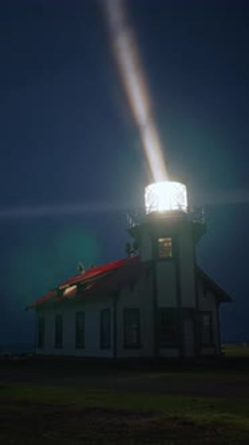 Vertical Night Lighthouse Glowing with Bright Beam and Fog