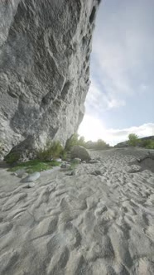Rock Formation on Sandy Beach Near Cliff