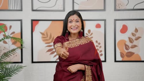 Elegant Woman Gives Thumbs Up Indoors