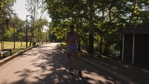 Woman Running in Park on Sunny Day