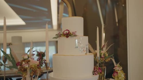 Elegant Tiered Wedding Cake Decorated with Flowers and Candles