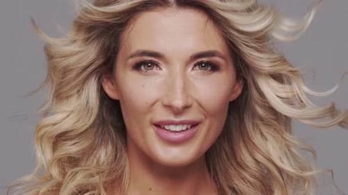 Studio Portrait of Young and Beautiful Blond Woman Over Grey Background Skin Care and Wellness