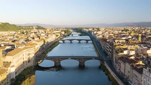 Beautiful Drone Flight Over the Arno River at Sunrise in the Italian City of Florence