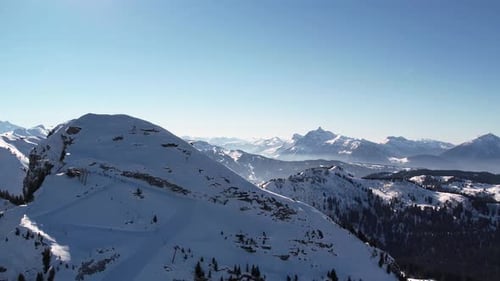 Aerial view of snowy mountain peaks in the Alps.