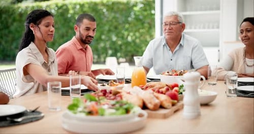 Family Enjoys a Meal Together Around the Table